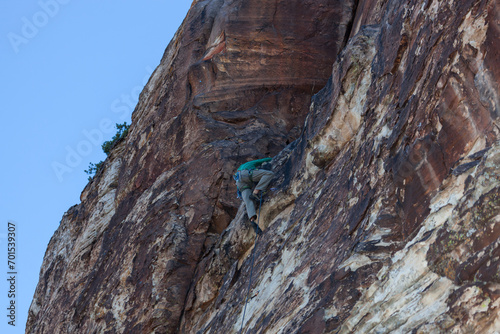 Rock Climber Reaching Ledge on Rock Wall