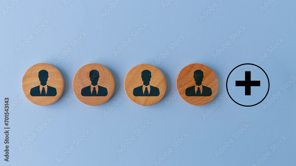Fototapeta premium Search for new employees. Hiring, staffing and employment. Personnel management. Leadership position. Wooden with employee symbols and plus sign. Creating a successful team. Vacant job position.