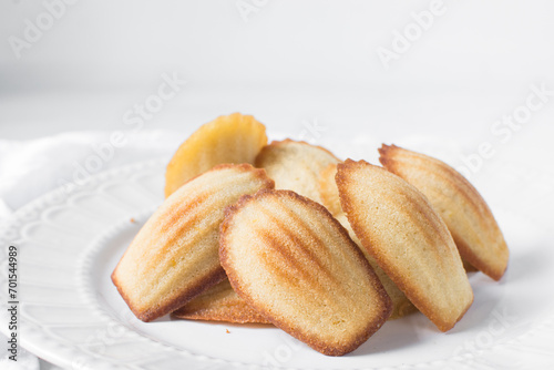vanilla madeleines on a white countertop, plain french vanilla madeleine cake or cookie photo