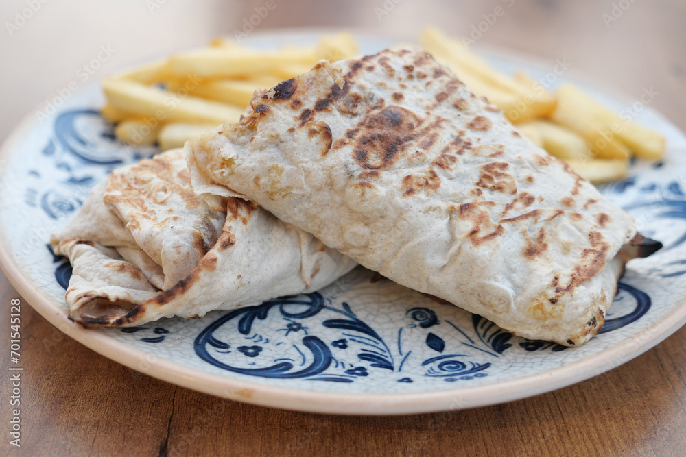 chicken warp and chips on a plate 