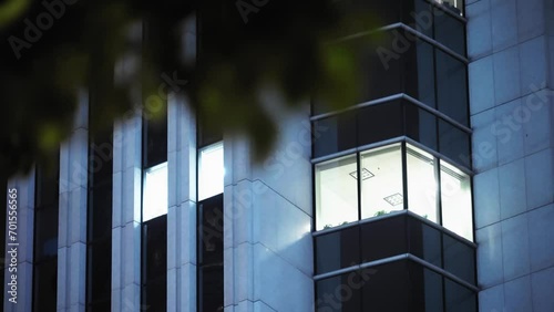 illuminated windows of office building at night photo