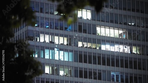 illuminated windows of office building at night photo