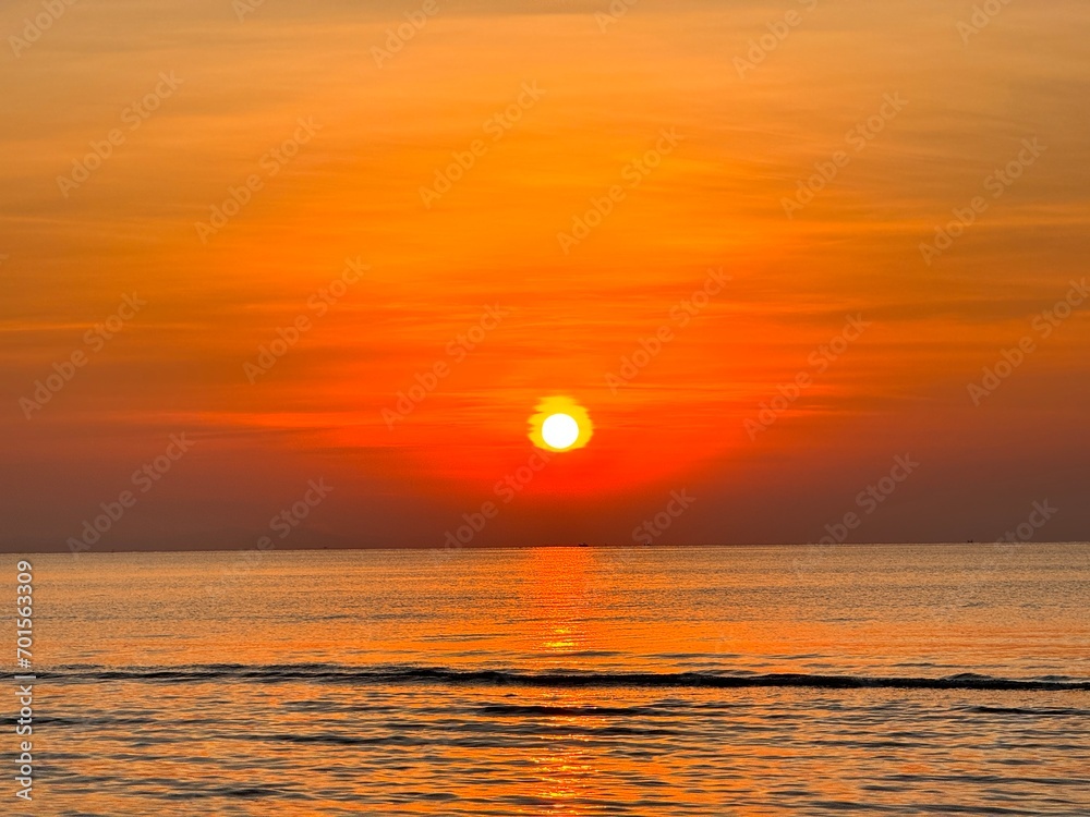 Sun going down in orange sky over horizon. Golden sunset at the sea with soft waves. Tropical sunset. Seascape and shore.
Sun going down in orange sky over horizon. Golden sunset at the sea with soft waves. Tropical sunset. Seascape and shore.