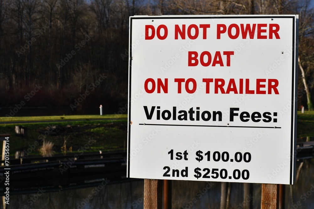 DO NOT POWER BOAT ON TO TRAILER, violation fee sign. DO NOT POWER BOAT ON TO TRAILER, violation fee sign.