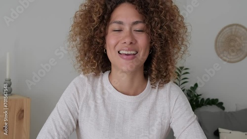 Screen view of young multiracial woman on online meeting talking and taking notes looking at camera. 4k video.