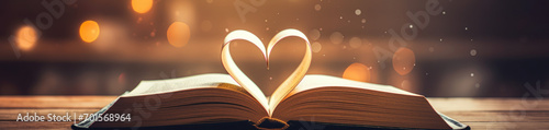Love story book with open page of literature in heart shape and stack piles of textbooks on reading desk in library, school study room for national library lovers month and education learning concept photo