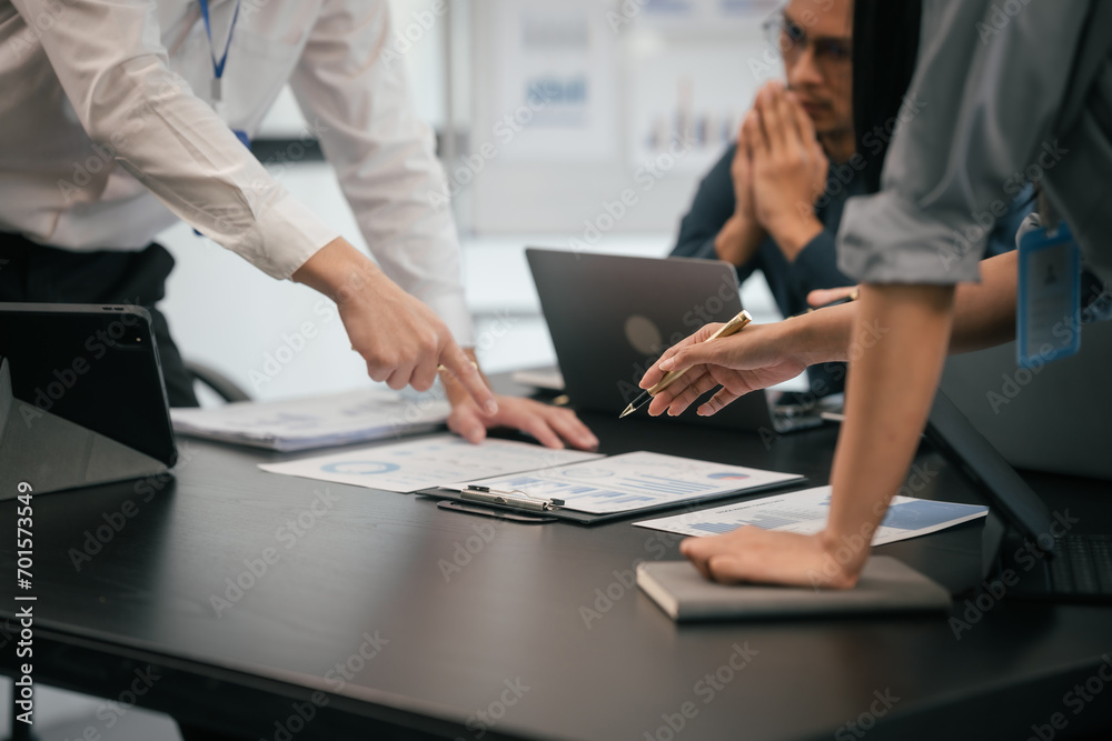diverse group of Asian professionals, including middle-aged and mature individuals, gathered around a table in a business setting, discussing documents with focused attention. diverse group of Asian professionals, including middle-aged and mature individuals, gathered around a table in a business setting, discussing documents with focused attention.