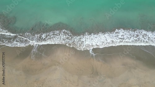 waves crashing on a beach (drone shot from above looking down) nobody, empty, idyllic tropical paradise view (luquillo puerto rico)  caribbean island travel destination for the holidays photo