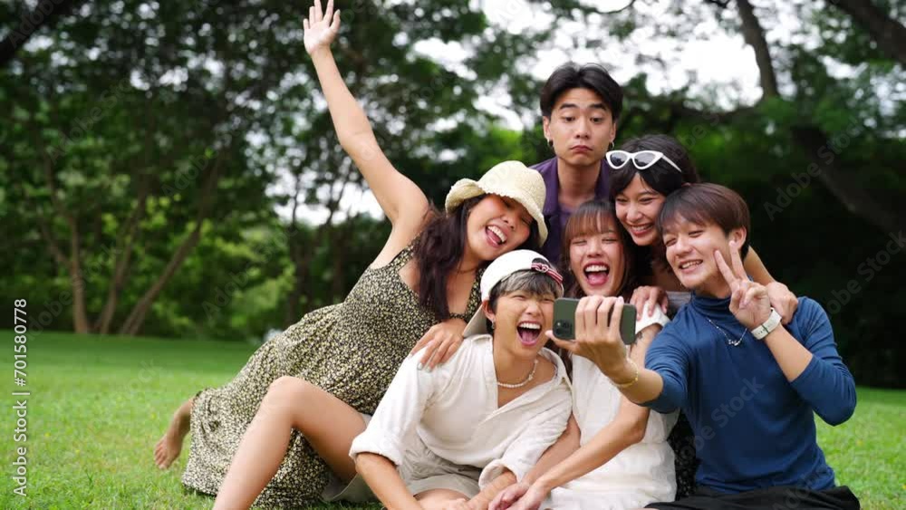 Happy young Asian man and woman enjoy and fun outdoor lifestyle travel nature on summer holiday vacation. Generation z people friends playing and using mobile taking selfie together at park. Happy young Asian man and woman enjoy and fun outdoor lifestyle travel nature on summer holiday vacation. Generation z people friends playing and using mobile taking selfie together at park.