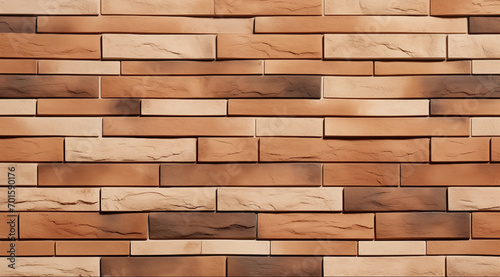 Stone wall thin, long, rectangular stone tiles arranged in a non-repeating pattern with various shades of tan and brown