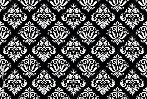 Wallpaper in the style of Baroque. Seamless vector background. White and black floral ornament. Graphic pattern for fabric, wallpaper, packaging. Ornate Damask flower ornament