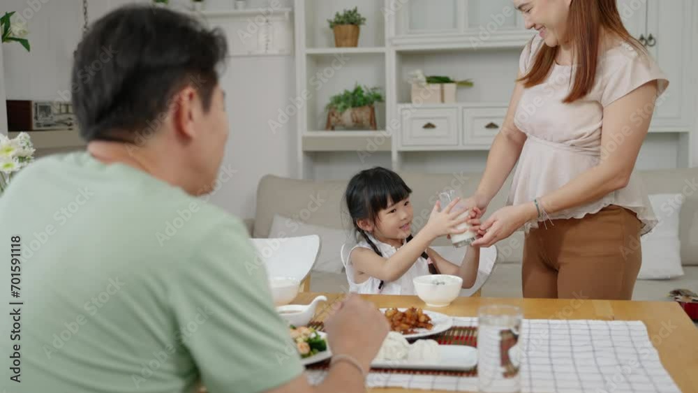 Asian family, daughter drinking milk at breakfast time
Asian family, daughter drinking milk at breakfast time