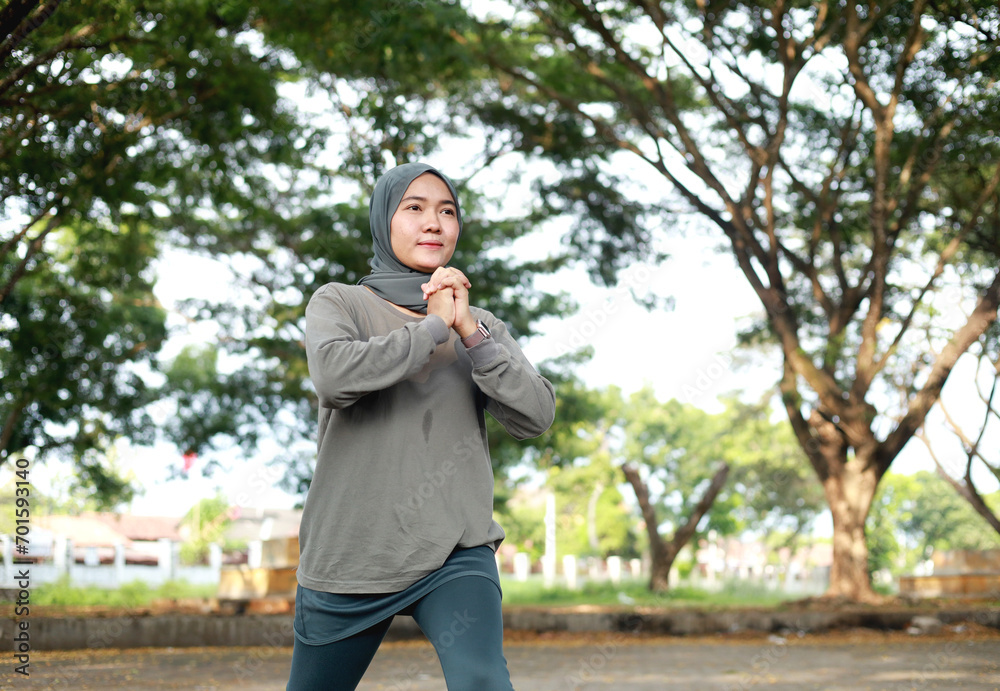 portrait of healthy asian woman with hijab doing exercise at the park in the morning portrait of healthy asian woman with hijab doing exercise at the park in the morning
