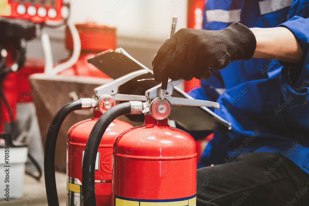 Engineer check fire suppression system,check fire extinguisher tank in the fire control room for safety