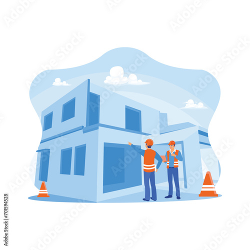 Civil engineers and supervisors are on a commercial building construction site. Engineer using the laptop to check building design. Experts inspect retail building construction site concepts. 