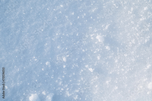 background with a texture of white blue snow on a snowdrift on a cold sunny winter day