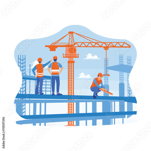 Construction team working on a building site. Construction engineer overseeing the progress of a construction project standing on a new concrete floor roof. Building construction sites concept.