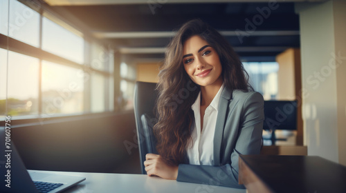 Portrait of young business woman sitting in the office smiling