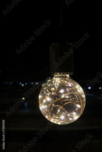 decorative beautiful light bulb in the dark night close up background