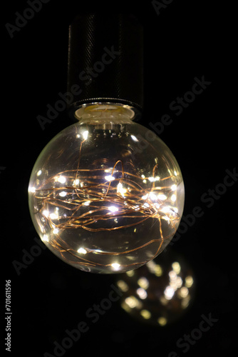 decorative beautiful light bulb in the dark night close up background