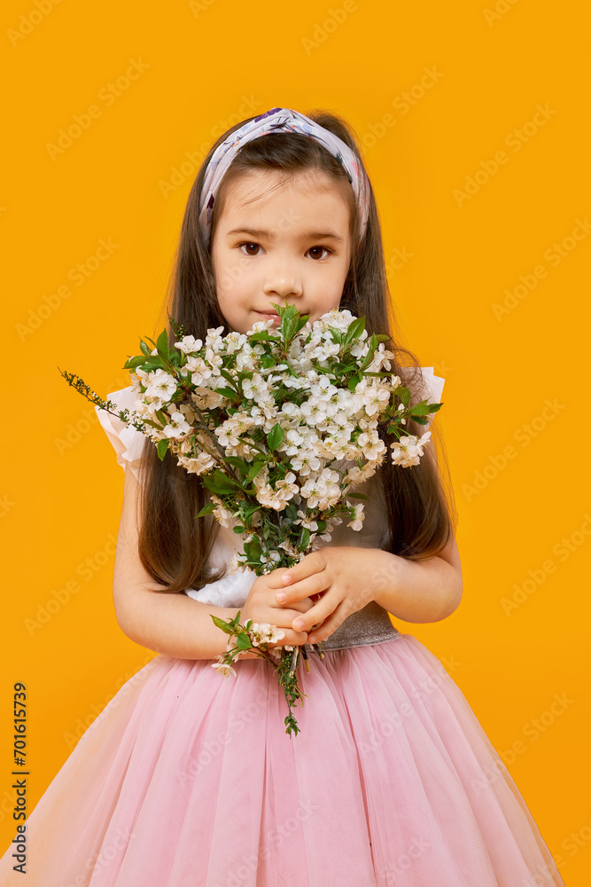 Cute young girl with bouquet of spring flowers Cute young girl with bouquet of spring flowers