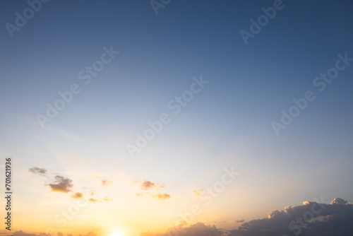 Beautiful sky and cloud at high. Include space, light of nature, sunset, sunrise. Colorful with yellow, orange and blue color at evening time in autumn for scene, backdrop, background and wallpaper. © DifferR