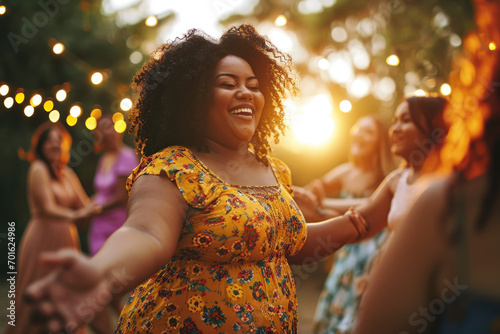 happy plus size women dancing together photo
