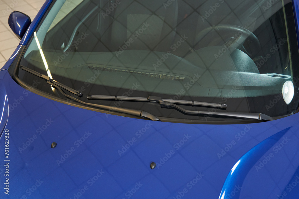 Obraz premium blue car windshield, steering wheel, front panel, wipers, washer nozzles mounted on the hood
