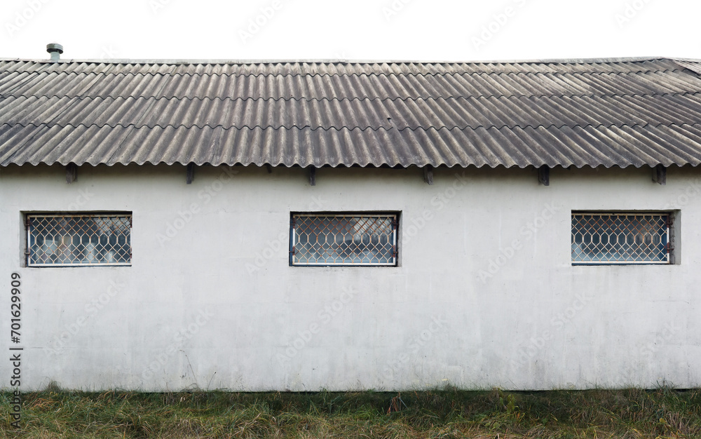 The windows of a rustic barn are protected by iron bars The windows of a rustic barn are protected by iron bars
