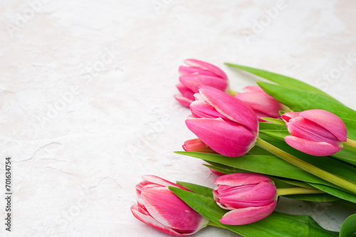Pink tulips bouquet white concrete background. Copy space