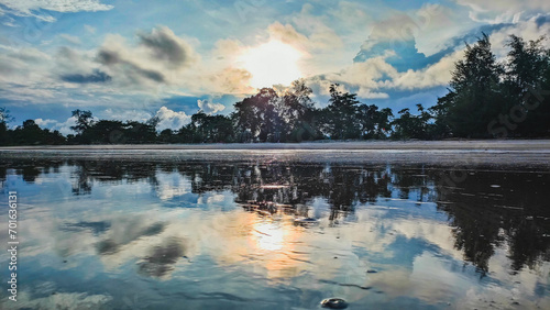 This is sunset at the beach in Pantai Anak Air Kuantan Pahang. This beautiful view was captured in the evening during cloudy day and the sea water reflects the view creates a symmetrical compositions.