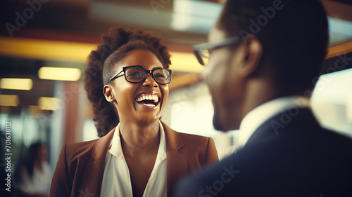 horizontal image of a young business woman laughing at the office with a colleague AI generated photo