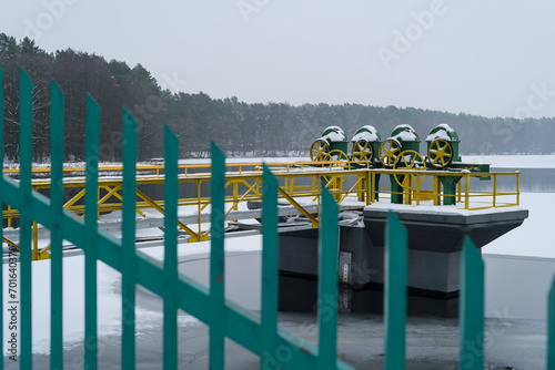 HYDROTECHNICAL CONSTRUCTION - Valves and other design elements on a lake in snow and winter landscape