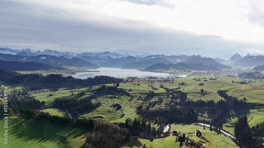 Scenic aerial view of village and artificial mountain lake during golden hour Scenic aerial view of village and artificial mountain lake during golden hour