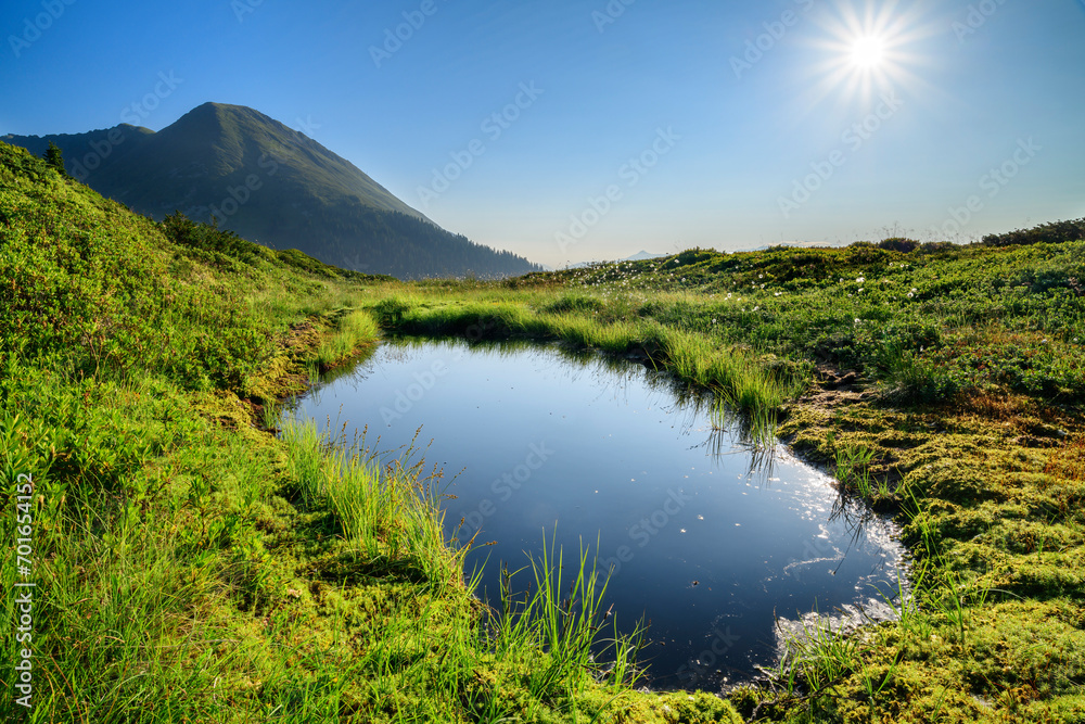 Austria, Tyrol, Sun shining over small lake in Tuxer Alps Austria, Tyrol, Sun shining over small lake in Tuxer Alps