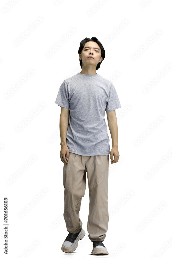 Fototapeta premium A guy in a gray T-shirt, on a white background, full-length