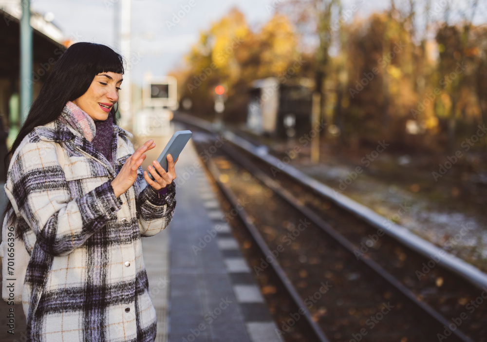 Smiling woman using mobile phone standing on platform Smiling woman using mobile phone standing on platform