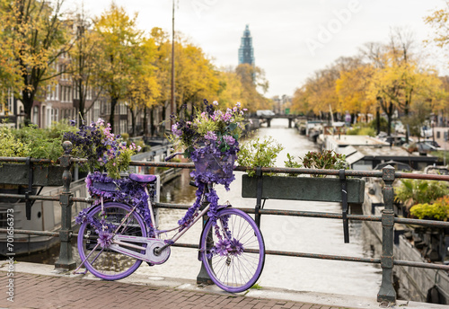 Purple bicycle with flowers on bridge photo