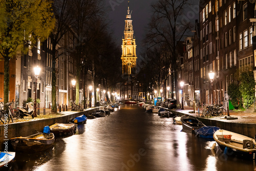 Boats moored along canal near Zuiderkerk church at Amsterdam, Netherlands photo
