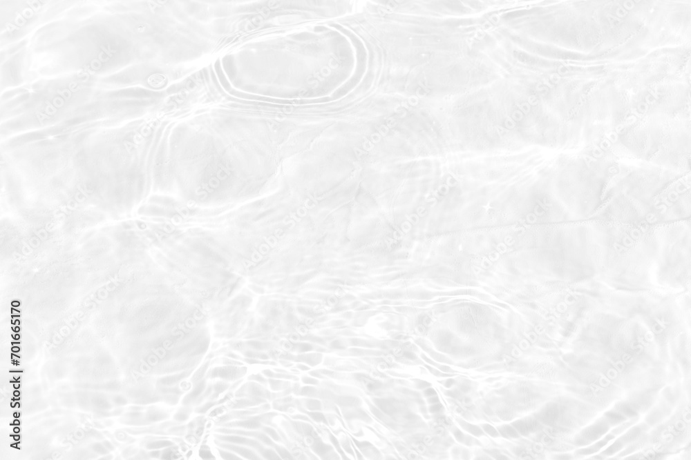 Obraz premium White water with ripples on the surface. Defocus blurred transparent white colored clear calm water surface texture with splashes and bubbles. Water waves with shining pattern texture background.