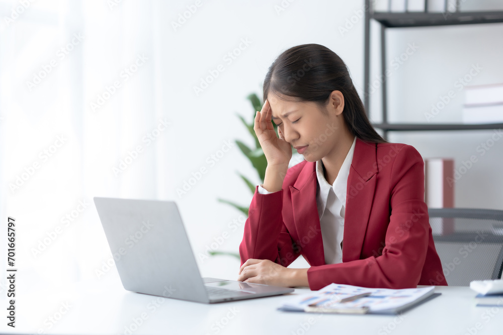 Stressed Asian Businesswoman Coping with Corporate Pressure at Office Desk. Workplace Burnout Concept. Stressed Asian Businesswoman Coping with Corporate Pressure at Office Desk. Workplace Burnout Concept.