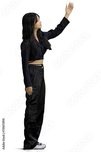 Tableau sur toile A woman in black clothes, on a white background, in full height, beckons to her