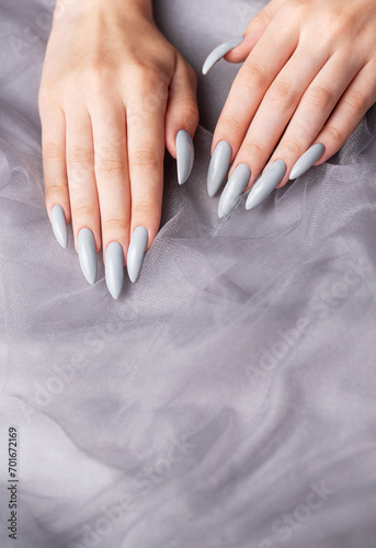 Grey nails on grey lace background.