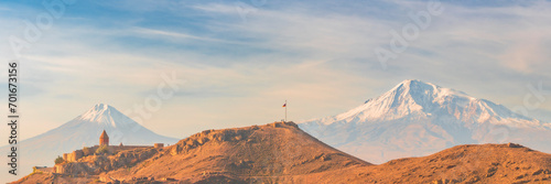 Wide angle panoramic view of sunrise with closeup of Ararat mountains with the Khor Virap monastery at fall. Travel destination Armenia photo