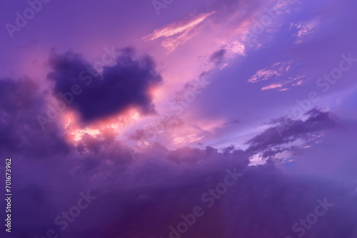Beautiful of soft and fluffy clouds in sunset shown purple and lilac sky with violet heart and brightness orange sun light.