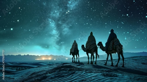 the three wise men of the east on their camels riding through the desert one night following the star of Bethlehem photo