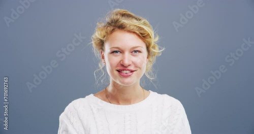 Woman, face and blowing kiss in studio for flirting, thank you or care gesture on gray background with mock up. Person, portrait and kissing emoji, expression or love for romance, gratitude and hands photo