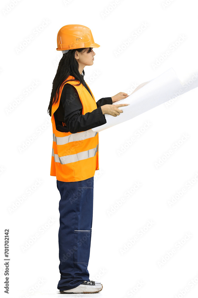 A construction girl on a green background, full-length, with drawings A construction girl on a green background, full-length, with drawings