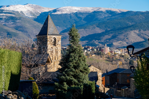 Church of Sant Vicenç de Saneja and in the background the city of Puigcerda in the area of Cerdanya in the province of Gerona in Catalonia Spain photo