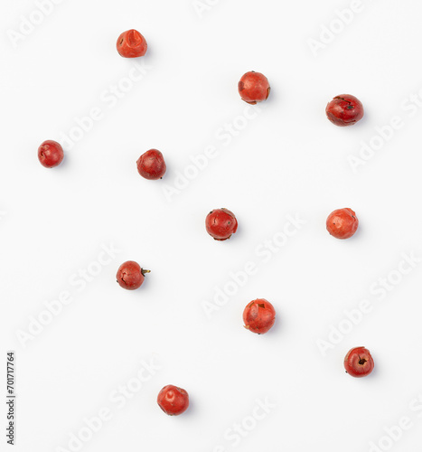 Red peppercorn seeds isolated on a white background.